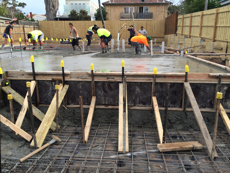 Crew screeding a new slab at a south-east suburban home
